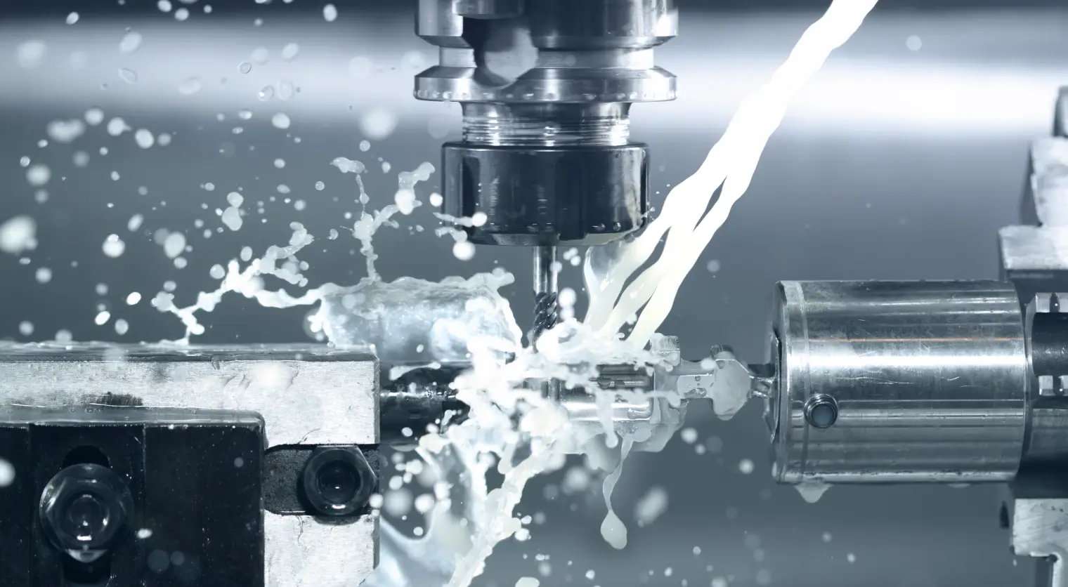 Close-up of a CNC plasma cutting machine cutting an intricate decorative eagle design into a flat metal sheet, with bright sparks flying and a CNC control panel visible in the background.